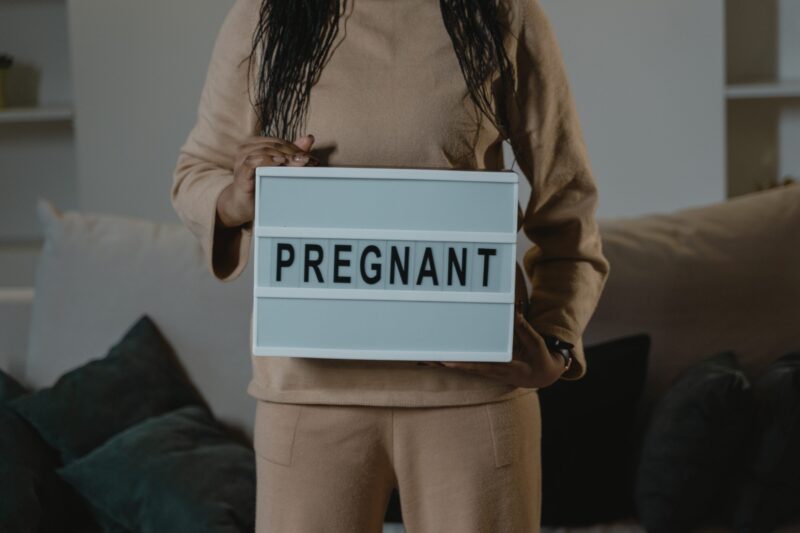 woman with pregnant sign